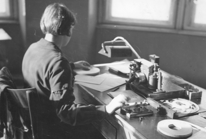 Urzędniczka nadająca telegram na aparacie szybkopiszącym systemu Bodo, Urząd Pocztowy w Krakowie, 1939 (domena publiczna, źródło NAC)